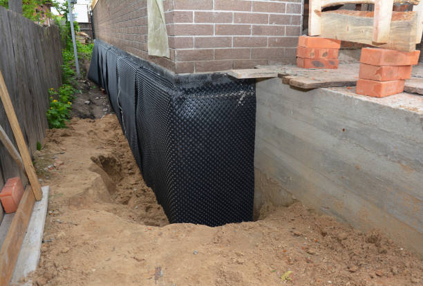 Happy homeowners after waterproofing job in Toney